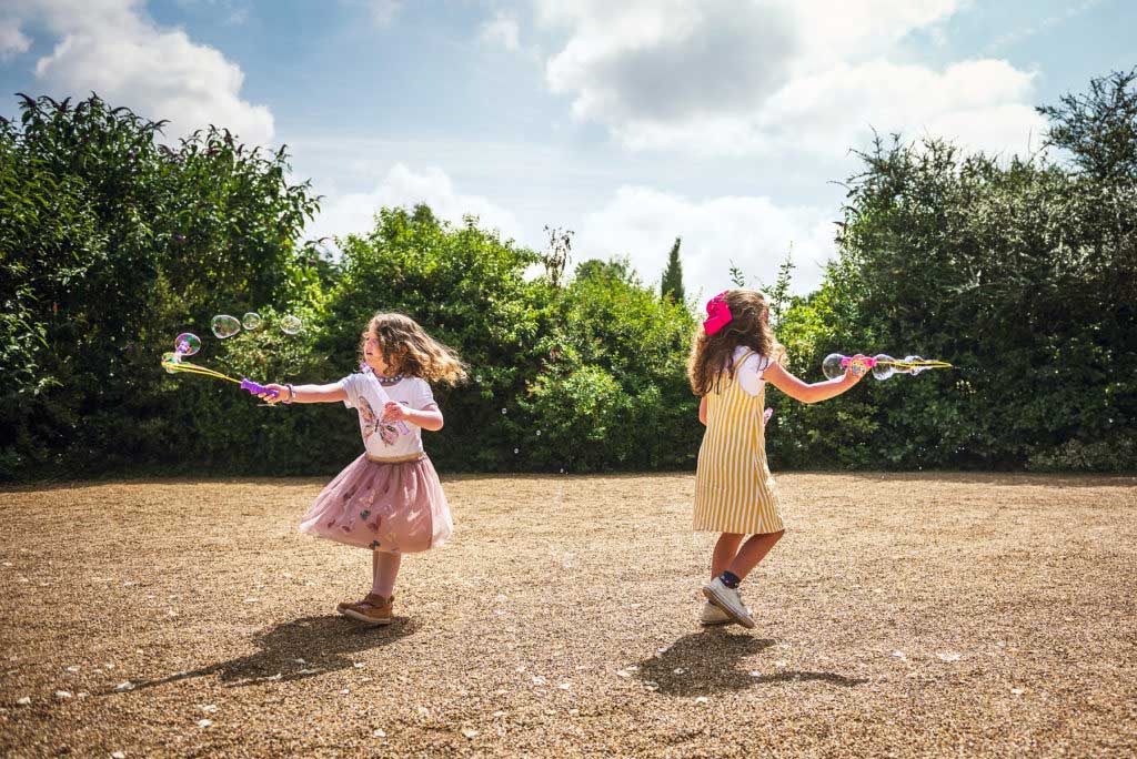 Fabulous festival wedding ideas kids playing bubbles 1